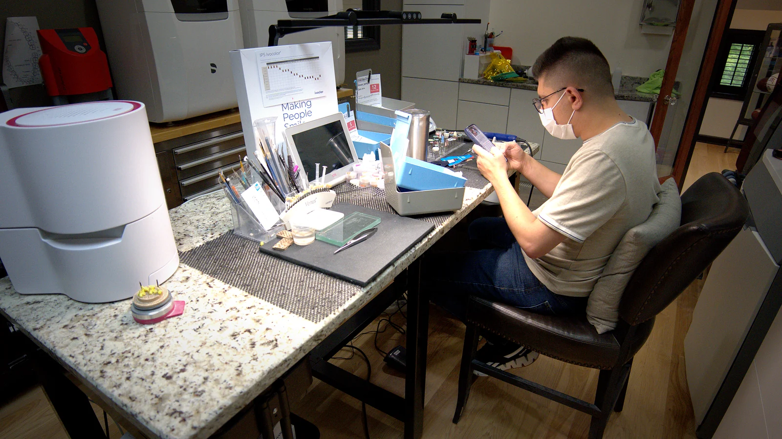 A technician working at the finishing bench in the lab